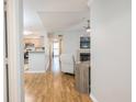 Open-concept living room features hardwood floors, fireplace, and bright, neutral paint at 700 Daniel Ellis Dr # 13302, Charleston, SC 29412