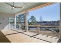 Spacious covered porch offers a relaxing outdoor living space with waterfront view at 7527 Ladys Secret Ln, Awendaw, SC 29429