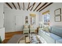 Bright living room features exposed wood beam ceilings and comfortable seating at 78 Nassau St, Charleston, SC 29403
