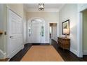 Bright foyer features hardwood floors, a decorative light, and arched entryways at 8587 Middleton Point Ln, Edisto Island, SC 29438