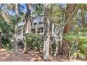 Charming home with a multi-level deck surrounded by lush landscaping and mature trees at 87 Dungannon Hall, Kiawah Island, SC 29455