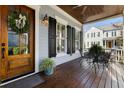 Charming front porch features dark stained wood floor, seating, and a view of the neighborhood at 914 Tupelo Bay Dr, Mount Pleasant, SC 29464
