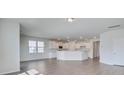 Open-concept living space with sleek wood-look floors flowing into the modern kitchen at 1012 Swamp Rose Run, Summerville, SC 29485