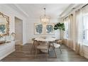 Elegant dining room with shiplap walls, modern chandelier, and large windows, creating a sophisticated and inviting space at 1016 Swamp Rose Run, Summerville, SC 29485