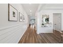 Bright entryway features wood flooring, white shiplap walls, recessed lighting, and decorative mirror, creating a welcoming ambiance at 1016 Swamp Rose Run, Summerville, SC 29485