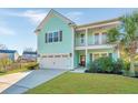 Beautiful two-story home boasting light teal siding, a cozy front porch, and a lush green lawn at 1089 Fort Johnson Rd, Charleston, SC 29412