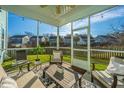 Inviting screened-in porch with comfortable seating, string lights, and views of the surrounding neighborhood at 1089 Fort Johnson Rd, Charleston, SC 29412