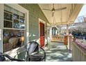 Inviting porch features a ceiling fan and swing for serene outdoor relaxation at 12 Poplar St, Charleston, SC 29403