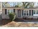 Close-up of a home's front entrance featuring brick steps and gray door at 1239 Wappetaw Pl, Mount Pleasant, SC 29464