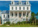 Bright, spacious two-story home with a welcoming front porch and coastal design at 1468 Alligator Creek Ct, Awendaw, SC 29429
