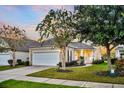 Beautiful single-Gathering house offers a two-car garage, manicured lawn, and welcoming front entrance at 174 Sea Lavender Ln, Summerville, SC 29486