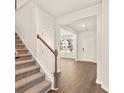 Inviting foyer with wood floors, staircase, and a view into the living space showcasing an open floor plan at 1832 Nola Run, Summerville, SC 29485