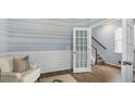 Bright living room with an accent wall that leads to the home's staircase and second level at 1844 Nola Run, Summerville, SC 29485