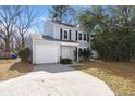 Two story home featuring a well-maintained lawn, driveway, and charming curb appeal at 2028 Wild Flower Lane, Charleston, SC 29414