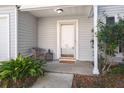 Cozy front porch with a chair, plants, and a welcoming door at 2028 Wild Flower Lane, Charleston, SC 29414