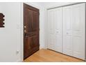 Entryway features hardwood floor, a dark wood front door, and white closet with bifold doors at 2244 Ashley Crossing Dr # 1232, Charleston, SC 29414