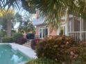 Beautiful pool with landscaping and seating, offering a private outdoor oasis for relaxation at 24 Commons Ct, Isle of Palms, SC 29451