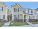 View of the exterior featuring the covered entryway of the townhome and the landscaped front yard at 249 Brookshire Rd, Goose Creek, SC 29445