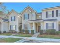Charming exterior of multi-story townhome featuring a covered porch and manicured landscaping at 249 Brookshire Rd, Goose Creek, SC 29445