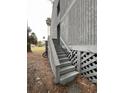 Exterior shot of the apartment featuring a set of weathered stairs leading to a ground-level entrance at 291 Sea Cloud Cir # 291, Edisto Island, SC 29438