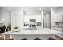 Bright kitchen featuring a large island with granite countertops and white cabinetry at 301 Pine Crest View Dr, Summerville, SC 29486