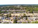 Aerial view of a brick home in a neighborhood surrounded by lush greenery at 3334 Merion Pl, Mount Pleasant, SC 29466
