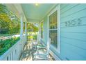 Inviting porch featuring white rocking chairs, perfect for relaxing and enjoying the outdoors at 5302 E Dolphin St, North Charleston, SC 29405