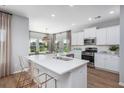 Bright kitchen with stainless steel appliances, white cabinets, quartz countertops, and bar stool seating at the island at 564 Richfield Way, Summerville, SC 29486