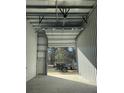 Bright interior with concrete floors, white walls, and a partially open garage door showing a truck outside at 565 Faison Rd # 57, Mount Pleasant, SC 29466