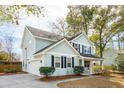 Charming two-story home featuring light blue siding, black shutters and attached garage at 716 Muirhead Rd, Mount Pleasant, SC 29464