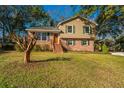 Charming two-story home with a brick facade and a large grassy front yard at 7639 Northhaven Dr, North Charleston, SC 29420