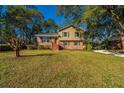 Charming two-story home with a brick facade and a large grassy front yard at 7639 Northhaven Dr, North Charleston, SC 29420
