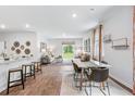 Bright open concept living and dining area with wood flooring and natural light from large windows at 838 Lilyford Ln, Summerville, SC 29486