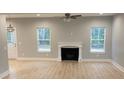 Spacious living room featuring a fireplace, wood-look floors, and two windows offering ample natural light at Ln, Walterboro, SC 29488