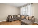 Comfortable living room with a sectional sofa, natural light, and neutral color scheme at 103 Cardinal Flower Ct, Moncks Corner, SC 29461