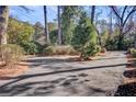 Circular driveway with mature trees and greenery, offering privacy and a serene setting for the property at 108 Tea Farm Rd, Summerville, SC 29483