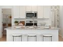 Stylish kitchen island with granite countertops and seating for three at 116 Threaded Fern St, Summerville, SC 29485