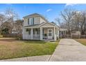 Well-maintained two-story home with a cozy front porch and a neatly kept lawn at 12 Palmetto Park Dr, Charleston, SC 29407