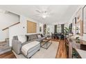 Bright living room featuring a plush gray sofa, stylish decor, and hardwood floors at 12 Palmetto Park Dr, Charleston, SC 29407