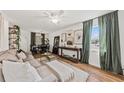 Spacious living room with a comfortable sofa, large windows, and hardwood floors at 12 Palmetto Park Dr, Charleston, SC 29407