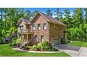 Beautiful home with a lush lawn, an attached garage, and verdant landscaping at 1208 Red Buckeye Ct, Moncks Corner, SC 29461