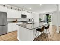 Open kitchen featuring a large island with seating, stainless steel appliances, and a dining area at 121 Loon Dr, Summerville, SC 29483