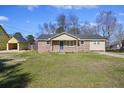 Lovely single-story home featuring brick accents and a well-maintained lawn on a sunny day at 127 Ridge Rd, Summerville, SC 29485