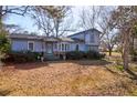Charming two-story home features blue siding and a well-manicured front yard at 133 Stephanie Cir, Summerville, SC 29483