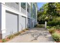 Spacious driveway leading to a gray two-car garage and fenced backyard, offering ample parking at 17 Trumbo St, Charleston, SC 29401