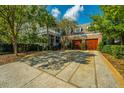 Spacious driveway leading to a garage with carriage doors, surrounded by mature trees at 186 N Shelmore Blvd, Mount Pleasant, SC 29464