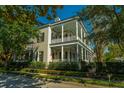 Beautiful two-story home with inviting white columned porches and manicured landscaping at 186 N Shelmore Blvd, Mount Pleasant, SC 29464