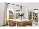 Bright dining area with a round table, modern chairs, large windows, and sliding doors leading to an outdoor patio at 200 Belfort Place, Summerville, SC 29486