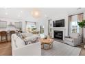 An inviting living space featuring a fireplace, modern furnishings, and an open layout that connects seamlessly to the kitchen at 200 Belfort Place, Summerville, SC 29486