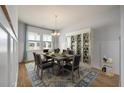Elegant dining room with stylish furniture, wainscoting, and natural light at 208 Evergreen Ave, Summerville, SC 29485
